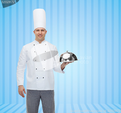 Image of happy male chef cook holding cloche