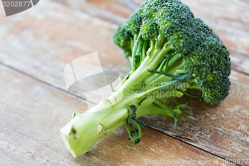 Image of close up of broccoli on wooden table