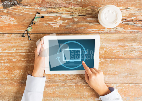 Image of close up of female hands with tablet pc and coffee