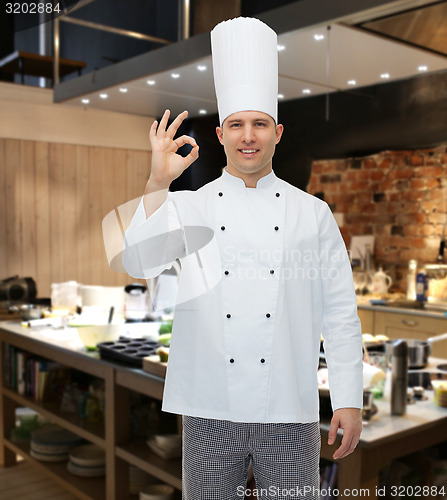 Image of happy male chef cook showing ok sign