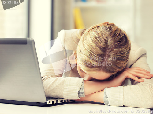 Image of tired woman with laptop computer