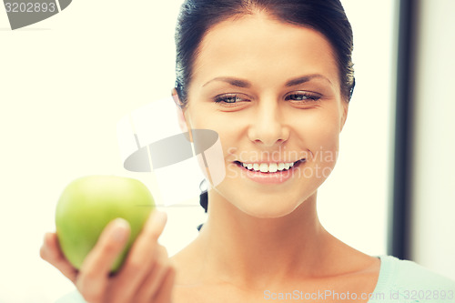 Image of lovely housewife with green apple
