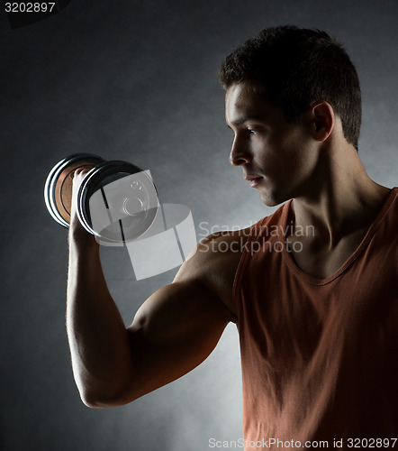 Image of young man with dumbbell