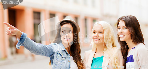 Image of beautiful girls looking for direction in the city