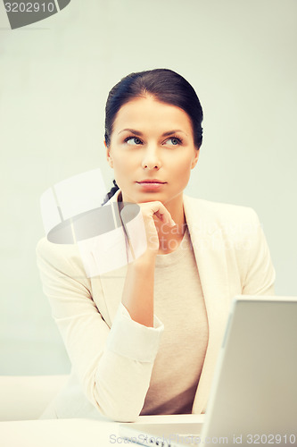 Image of pensive woman with laptop computer