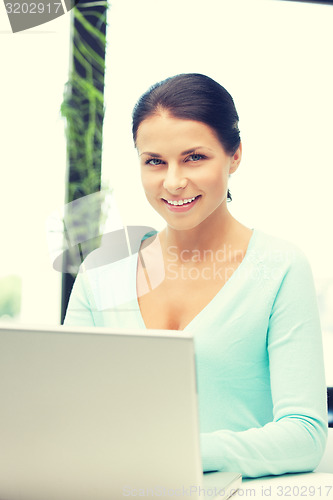 Image of happy woman with laptop computer
