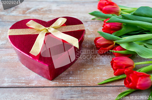 Image of close up of red tulips and chocolate box