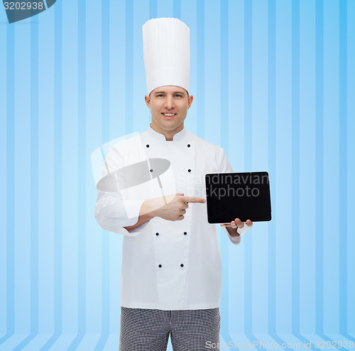 Image of happy male chef cook showing tablet pc