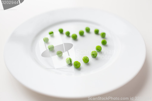 Image of close up of plate with peas in heart shape 