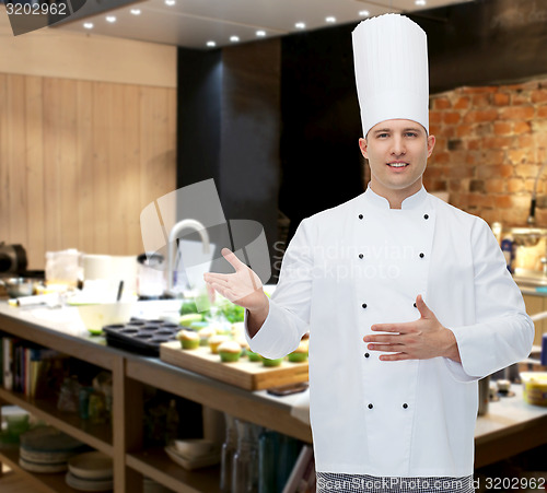 Image of happy male chef cook inviting