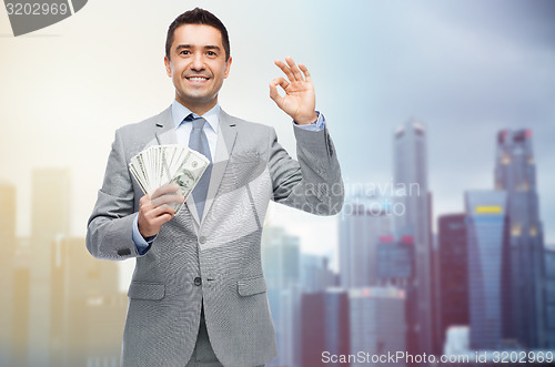 Image of smiling businessman with american dollar money