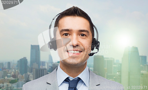 Image of smiling businessman in headset