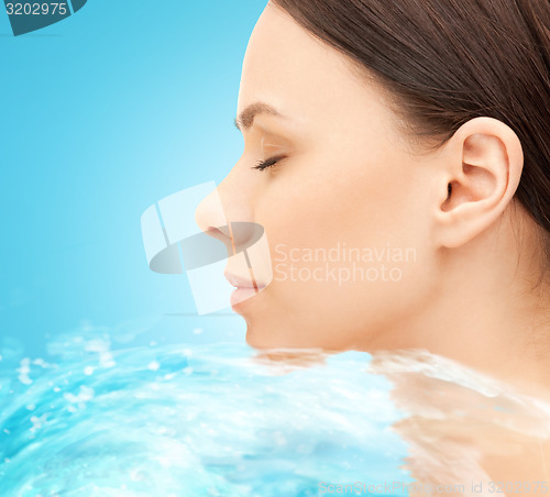 Image of face of beautiful young woman and water splash