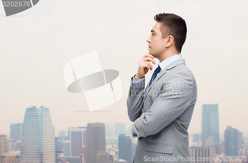 Image of thinking businessman in suit making decision