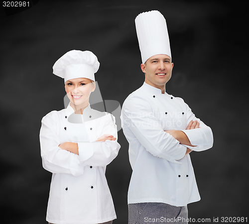 Image of happy male chef cook with crossed hands