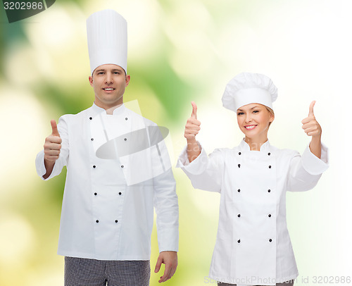 Image of happy male chef cook showing thumbs up