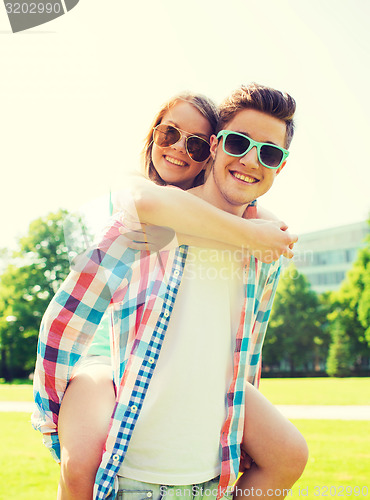 Image of smiling couple having fun in park