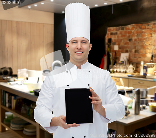 Image of happy male chef cook showing tablet pc