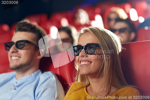 Image of happy friends watching movie in 3d theater