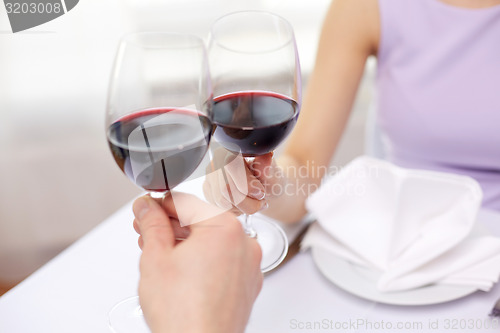 Image of young couple with glasses of wine at restaurant