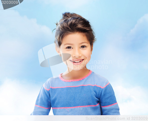 Image of little girl over blue sky background