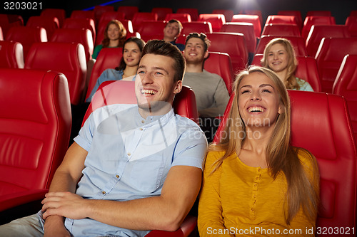 Image of happy friends watching movie in theater