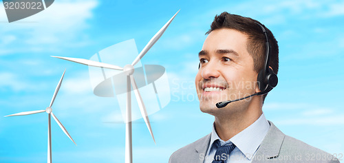 Image of smiling businessman in headset