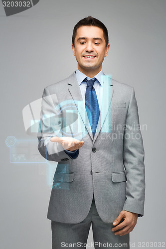 Image of happy businessman showing virtual chart projection