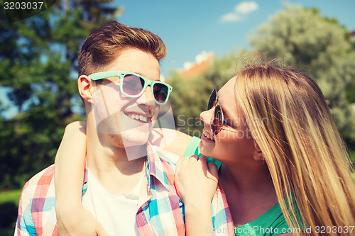 Image of smiling couple having fun outdoors