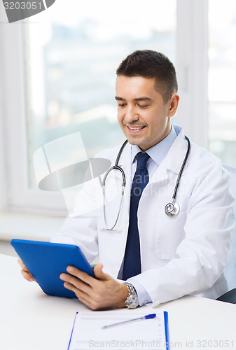 Image of smiling male doctor in white coat with tablet pc