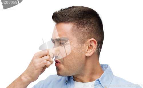 Image of man wrying of unpleasant smell