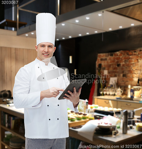Image of happy male chef cook holding tablet pc