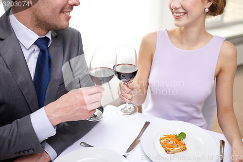 Image of happy couple with glasses of wine at restaurant