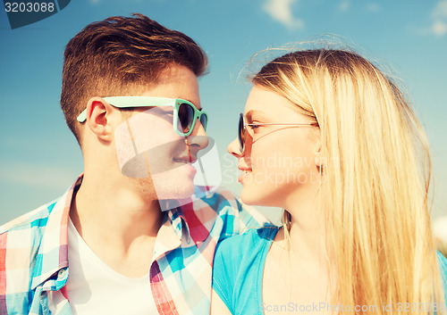 Image of smiling couple having fun outdoors