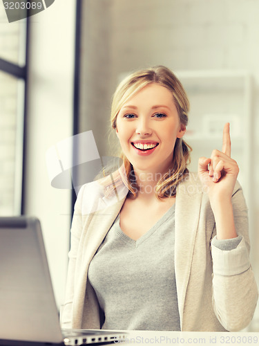 Image of woman with laptop and finger up