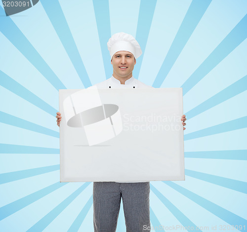 Image of happy male chef cook holding white blank big board