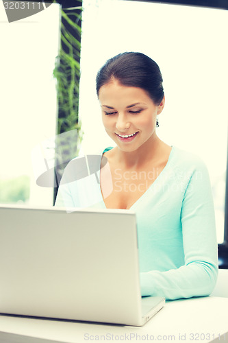 Image of happy woman with laptop computer