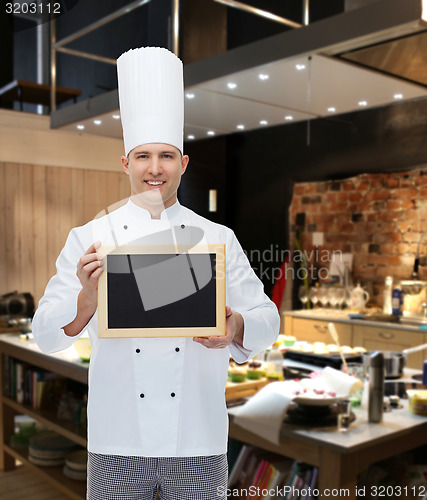 Image of happy male chef cook holding blank menu board