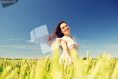 Image of smiling young woman on cereal field