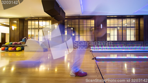 Image of Young man playing bowling