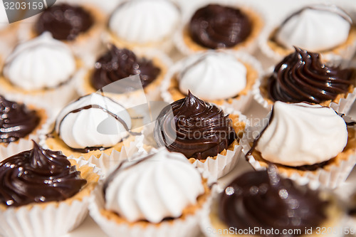 Image of white and black meringue cookies.