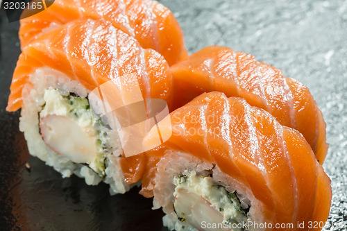 Image of Salmon and caviar rolls served on a plate