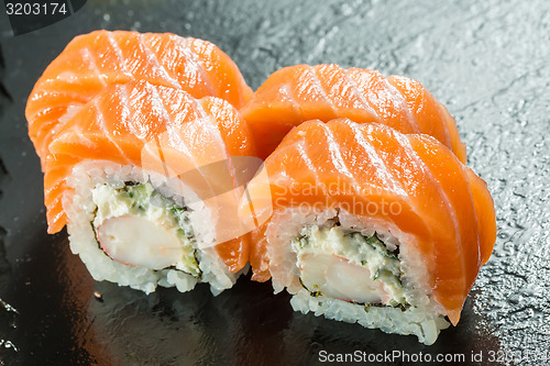 Image of Salmon and caviar rolls served on a plate