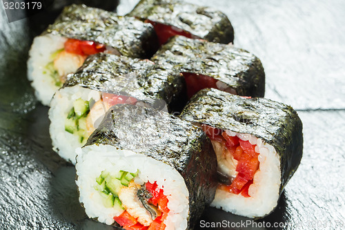 Image of Salmon and caviar rolls served on a plate