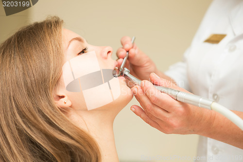 Image of Dentist curing a female patient