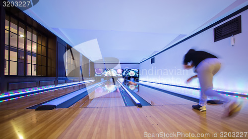 Image of Young man playing bowling