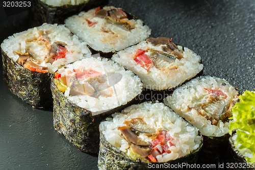 Image of Salmon and caviar rolls served on a plate