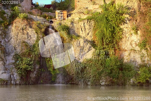 Image of Dirty sewage flow in mountain river