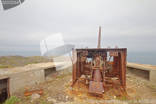 Image of old gun on the shores of the Scandinavian sea