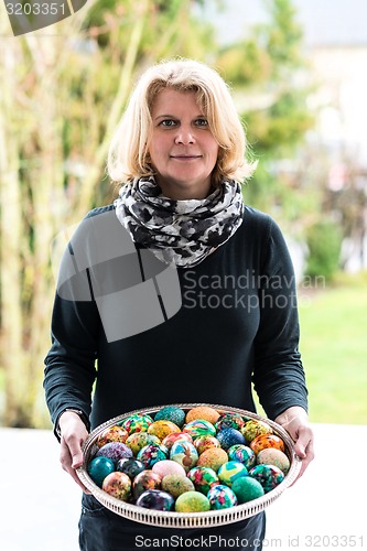 Image of woman presenting easter eggs